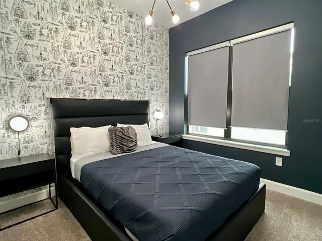 a bedroom with a bed and window