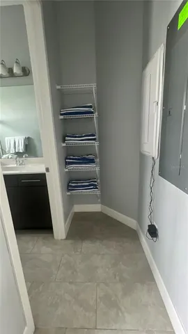 a room with a washing machine and storage
