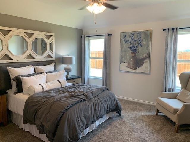 712 Feldspar Way Princeton, TX 75407 - Photo 8 of 12 Carpeted room featuring a ceiling fan, two windows with curtain rods, and neutral-toned walls
