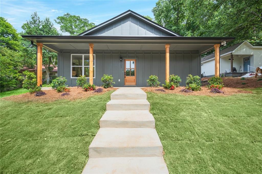 a front view of a house with yard and green space