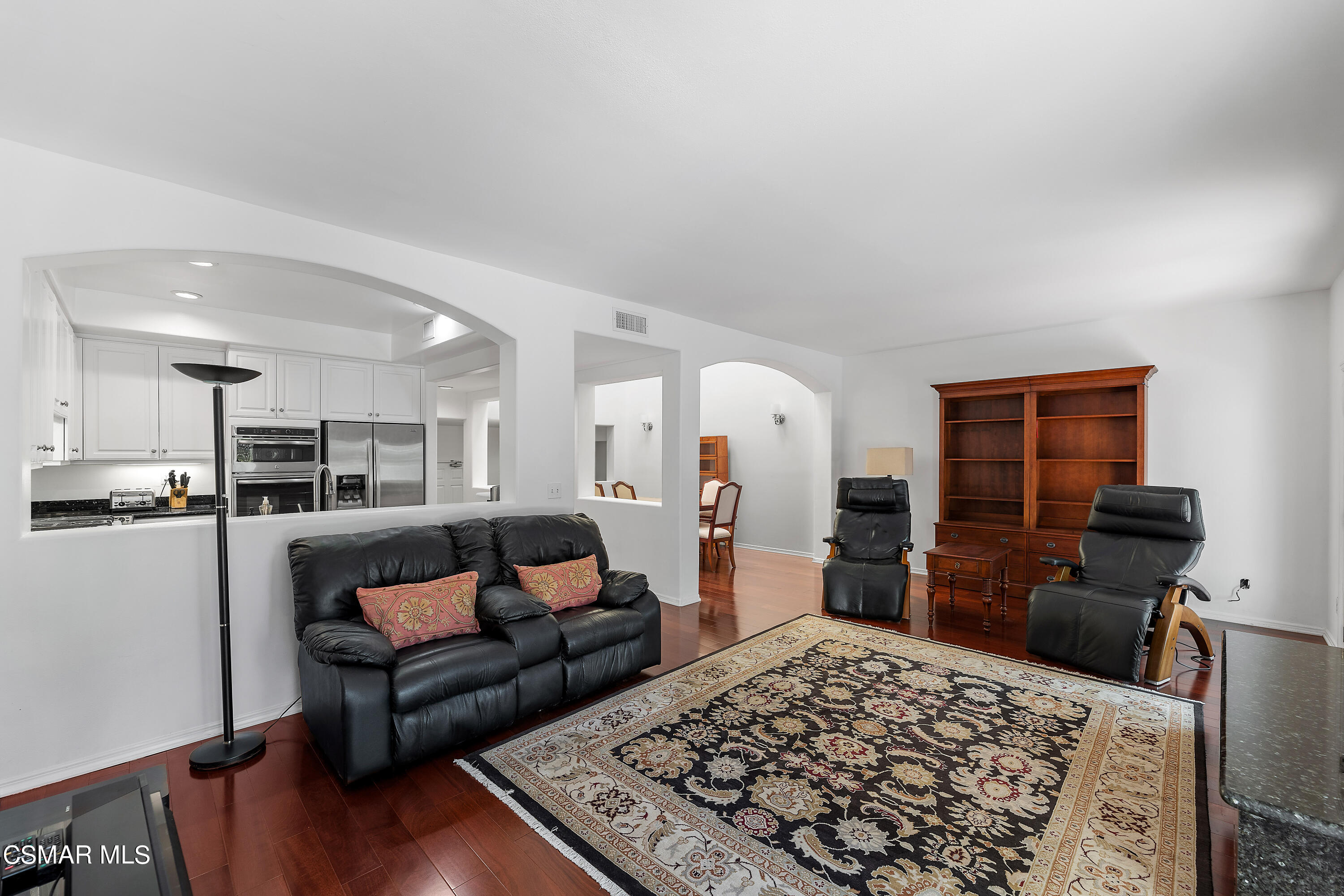 6435 Zumirez Drive, Unit 15 Malibu, CA 90265 - Photo 12 of 38 a living room with furniture and a rug
