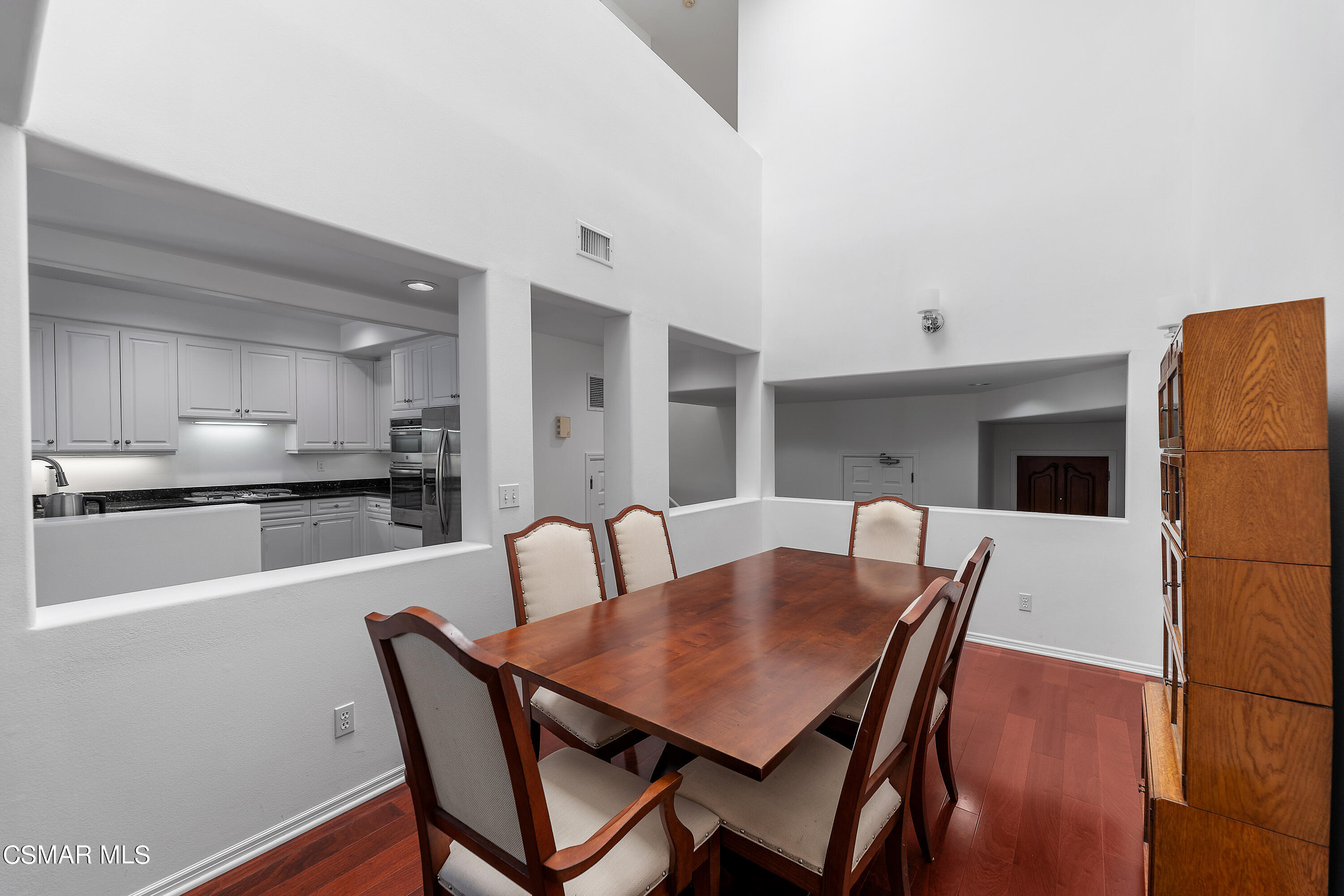 6435 Zumirez Drive, Unit 15 Malibu, CA 90265 - Photo 15 of 38 a view of a dining room with furniture and wooden floor