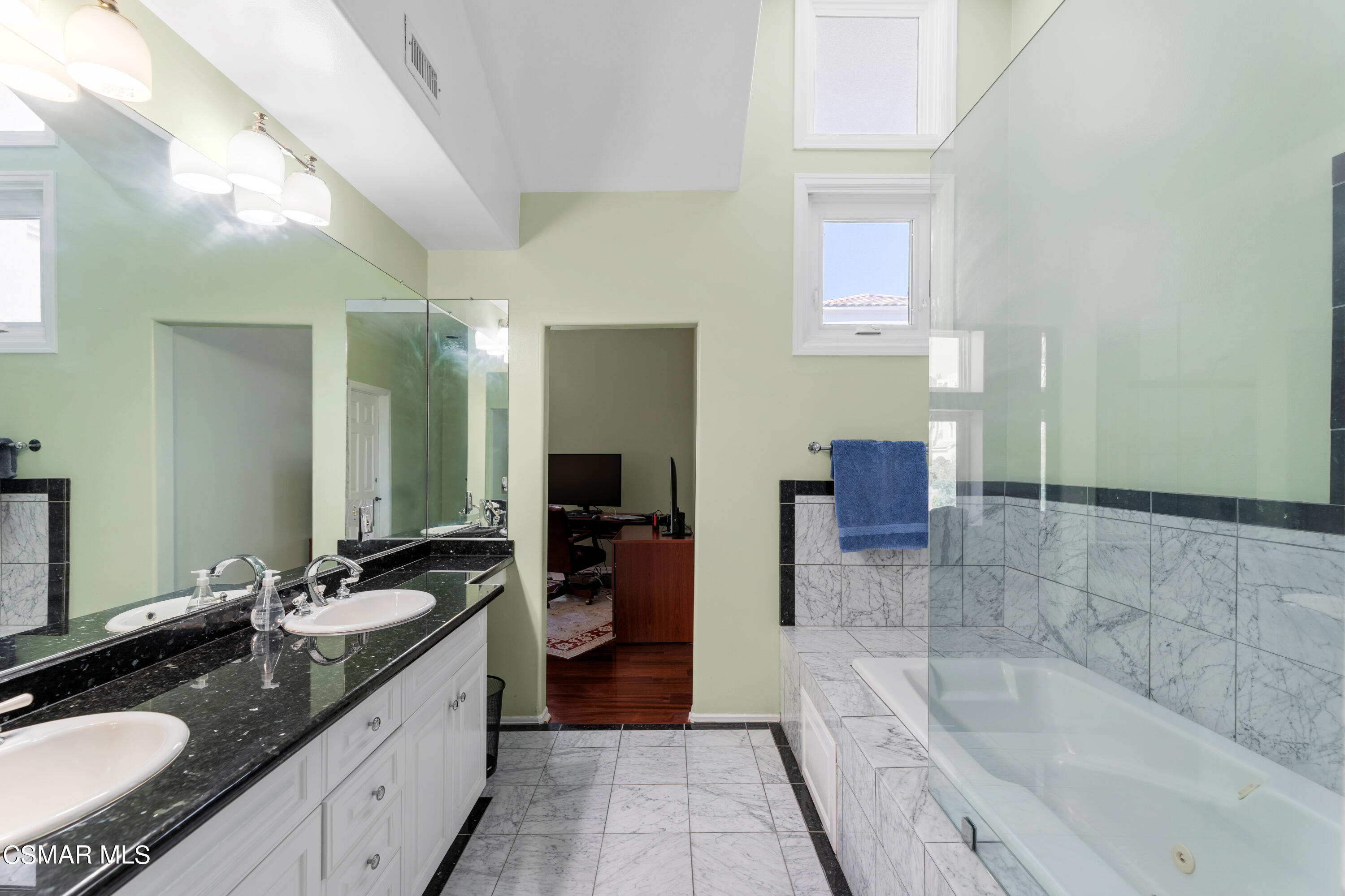 6435 Zumirez Drive, Unit 15 Malibu, CA 90265 - Photo 20 of 38 a bathroom with a granite countertop sink mirror and bathtub