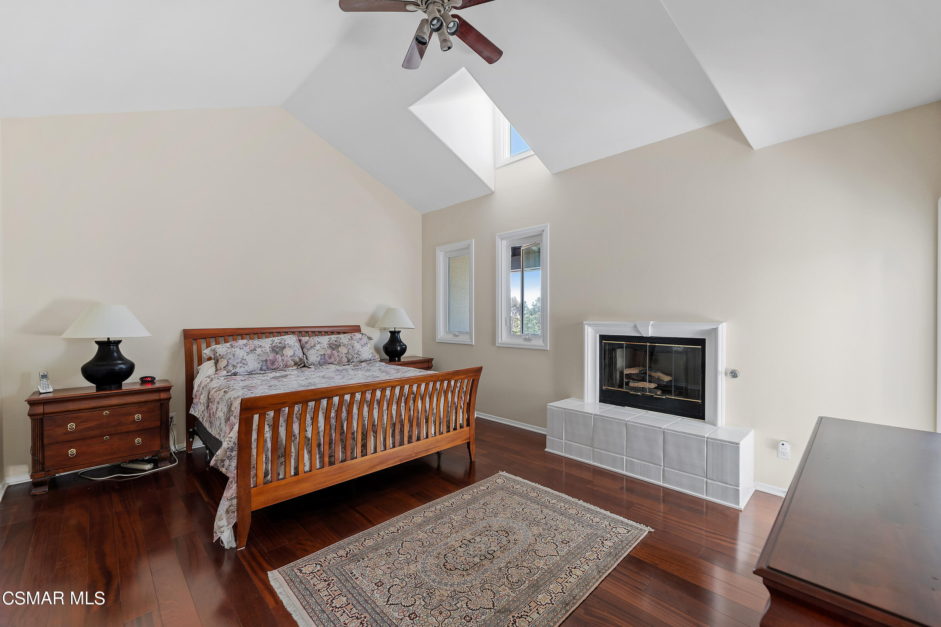 6435 Zumirez Drive, Unit 15 Malibu, CA 90265 - Photo 21 of 38 a bedroom with a bed and wooden floor