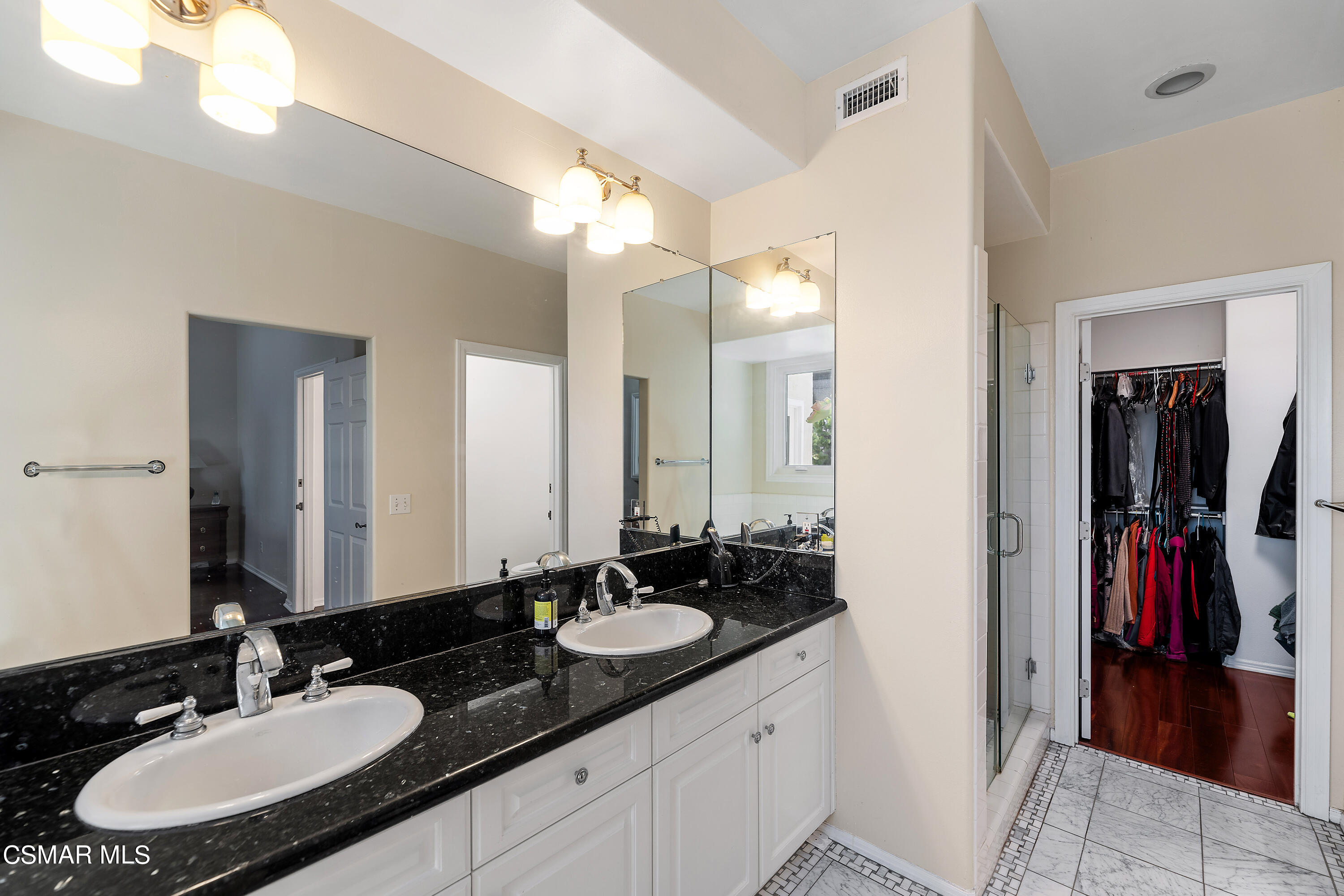 6435 Zumirez Drive, Unit 15 Malibu, CA 90265 - Photo 24 of 38 a bathroom with a sink and a mirror