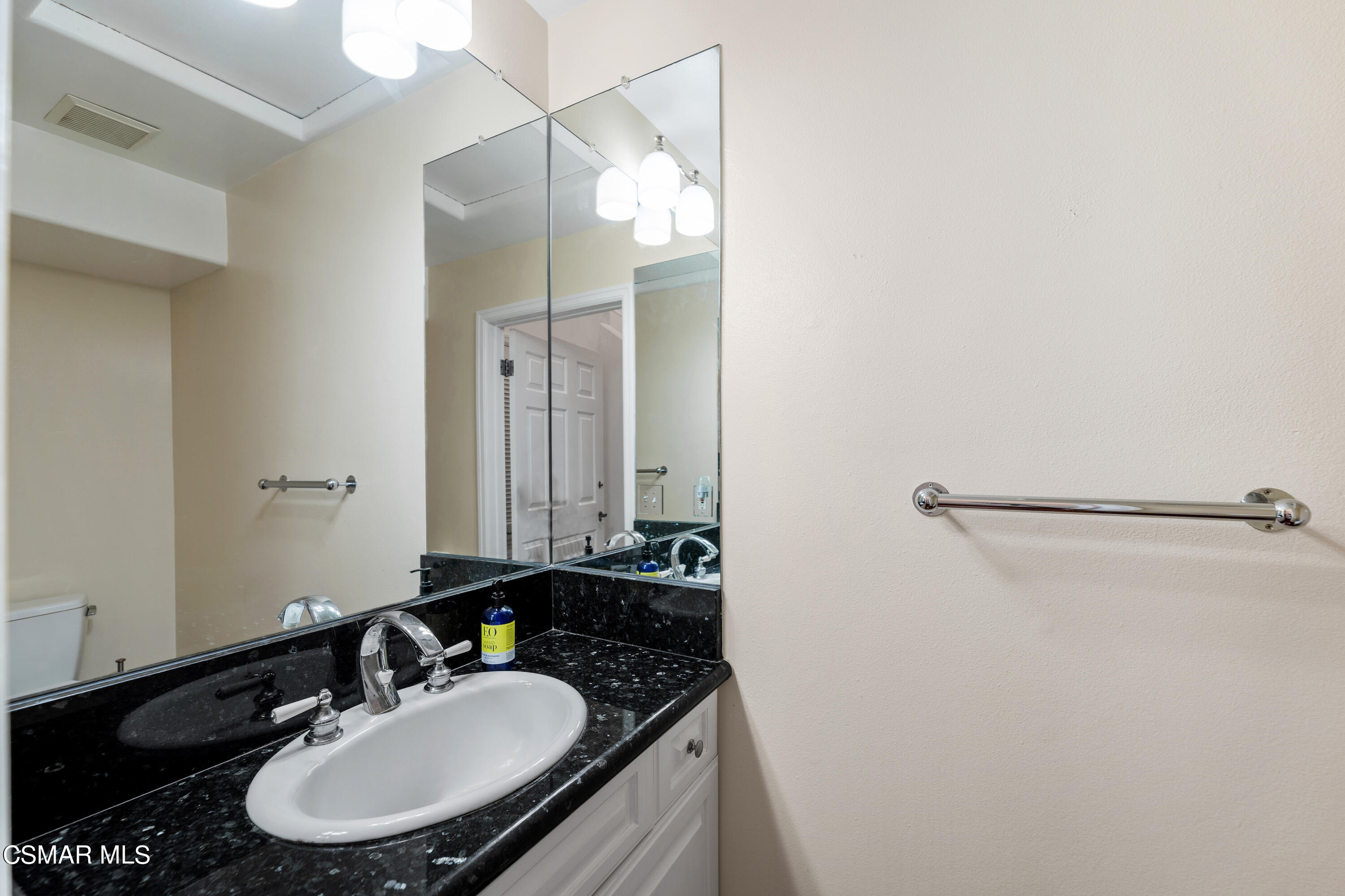 6435 Zumirez Drive, Unit 15 Malibu, CA 90265 - Photo 25 of 38 a bathroom with a sink and a mirror