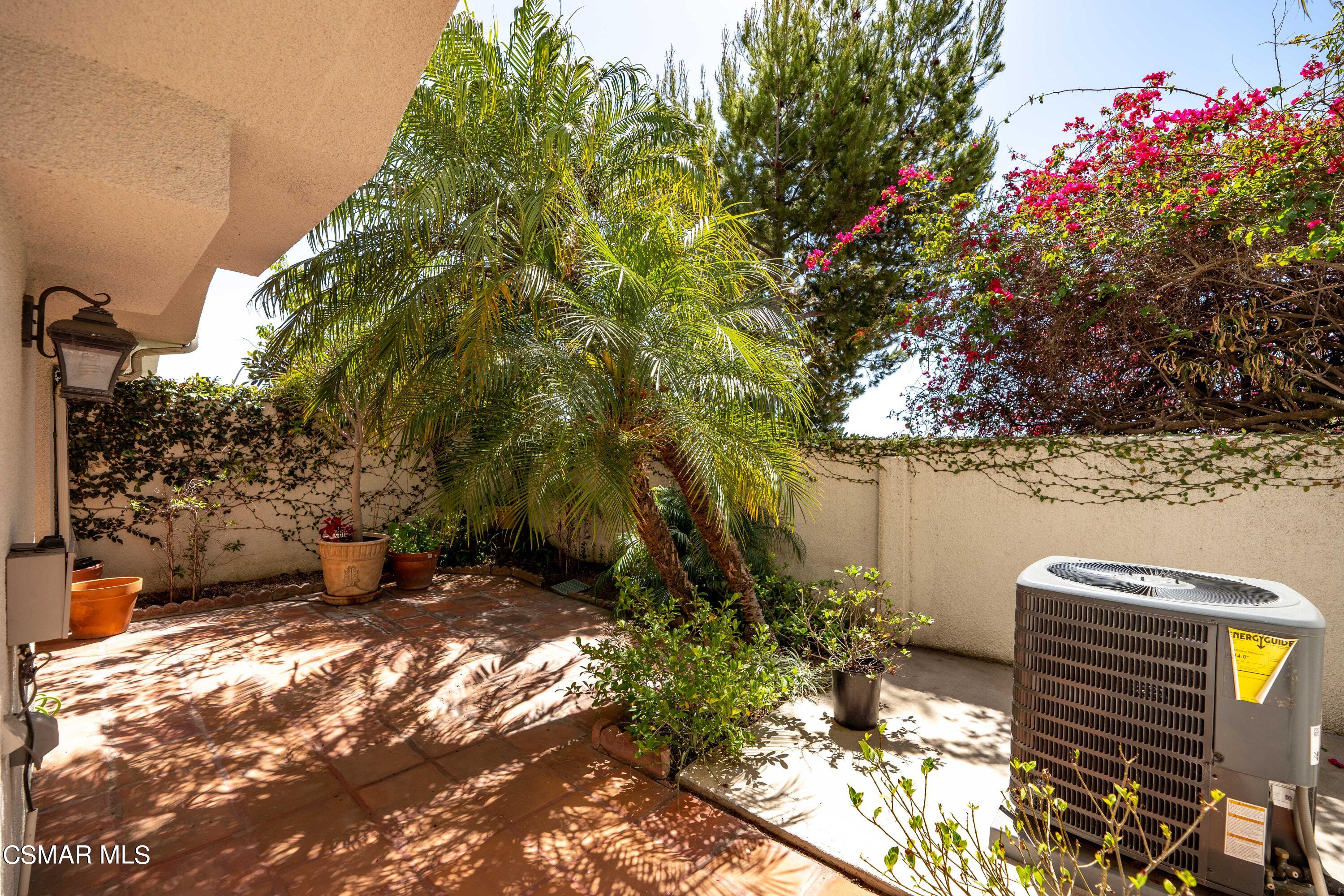 6435 Zumirez Drive, Unit 15 Malibu, CA 90265 - Photo 30 of 38 a backyard of a house with lots of green space