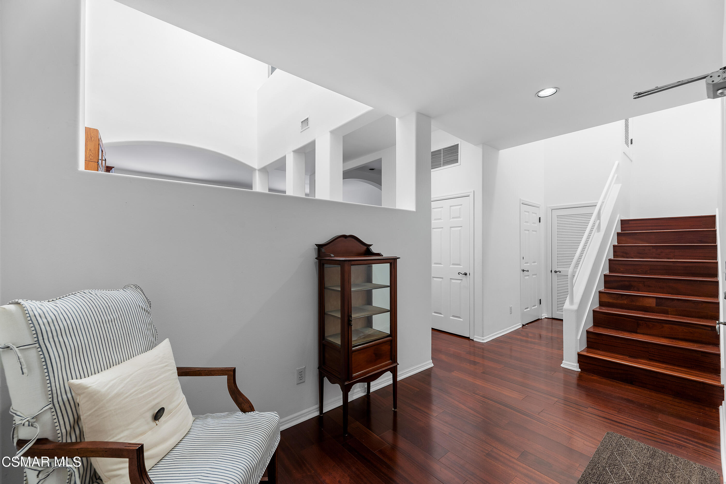 6435 Zumirez Drive, Unit 15 Malibu, CA 90265 - Photo 3 of 38 a view of a hallway with wooden floor and stairs