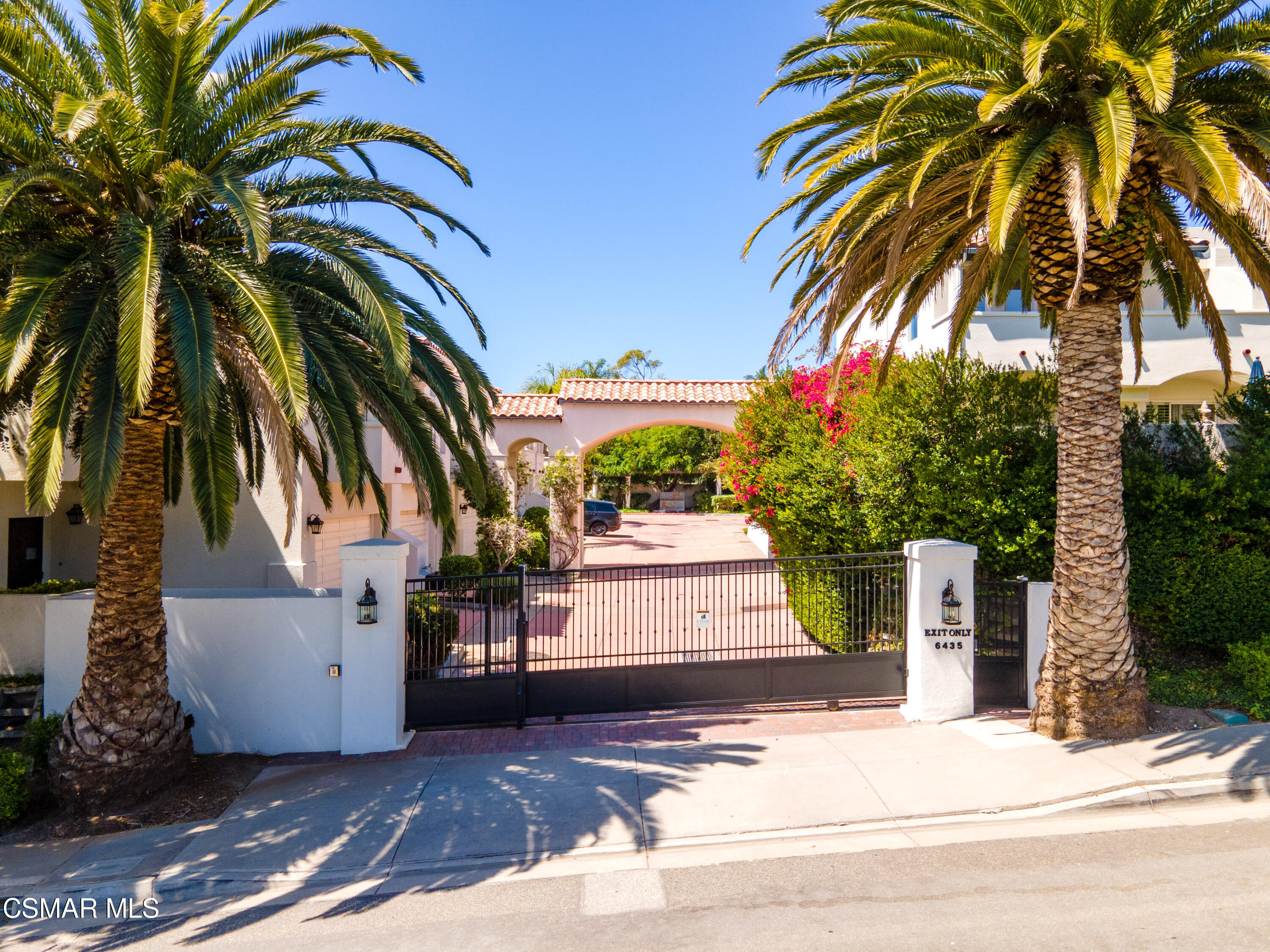 6435 Zumirez Drive, Unit 15 Malibu, CA 90265 - Photo 31 of 38 a view of a white house with a palm tree