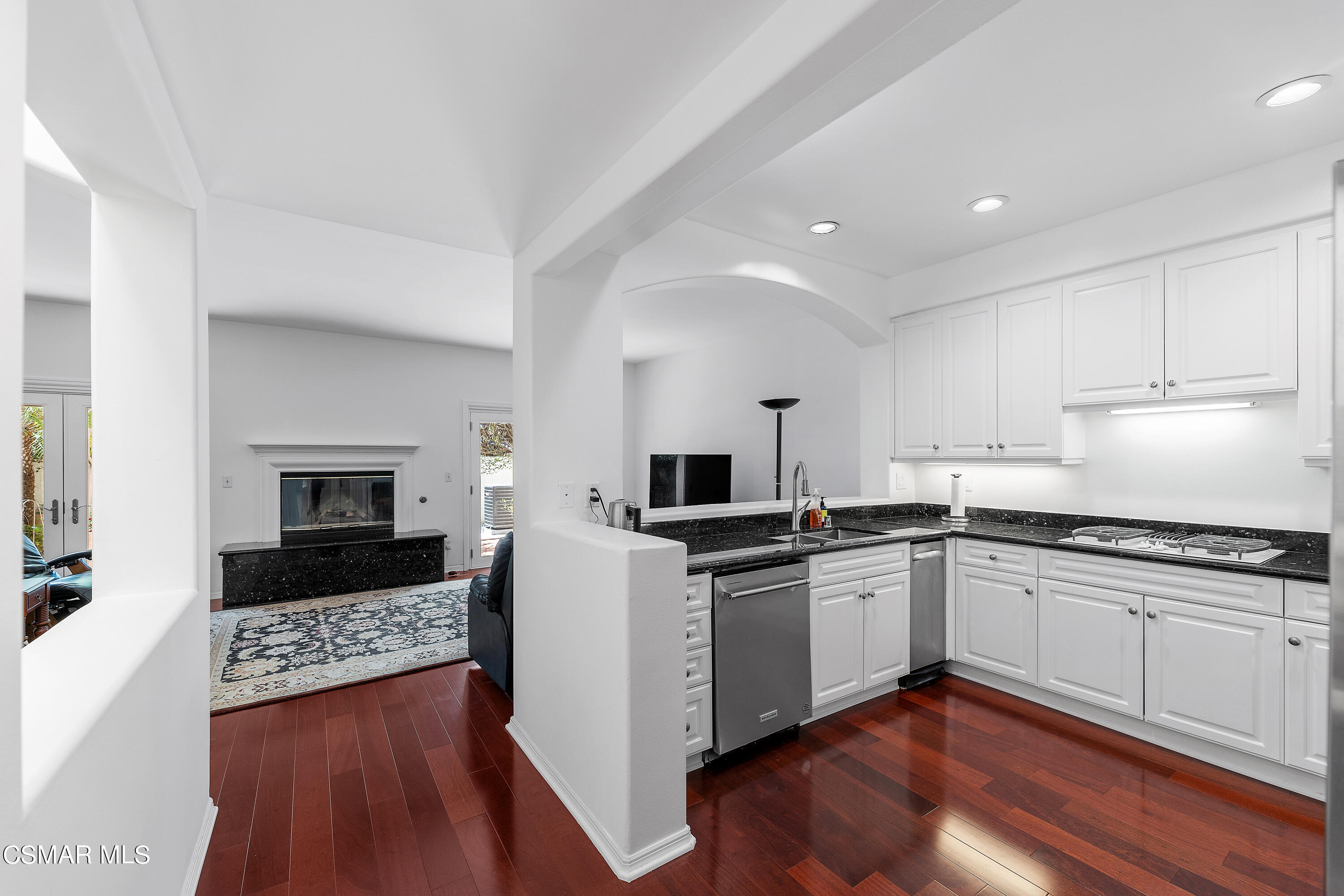 6435 Zumirez Drive, Unit 15 Malibu, CA 90265 - Photo 4 of 38 a kitchen with granite countertop a sink and steel appliances