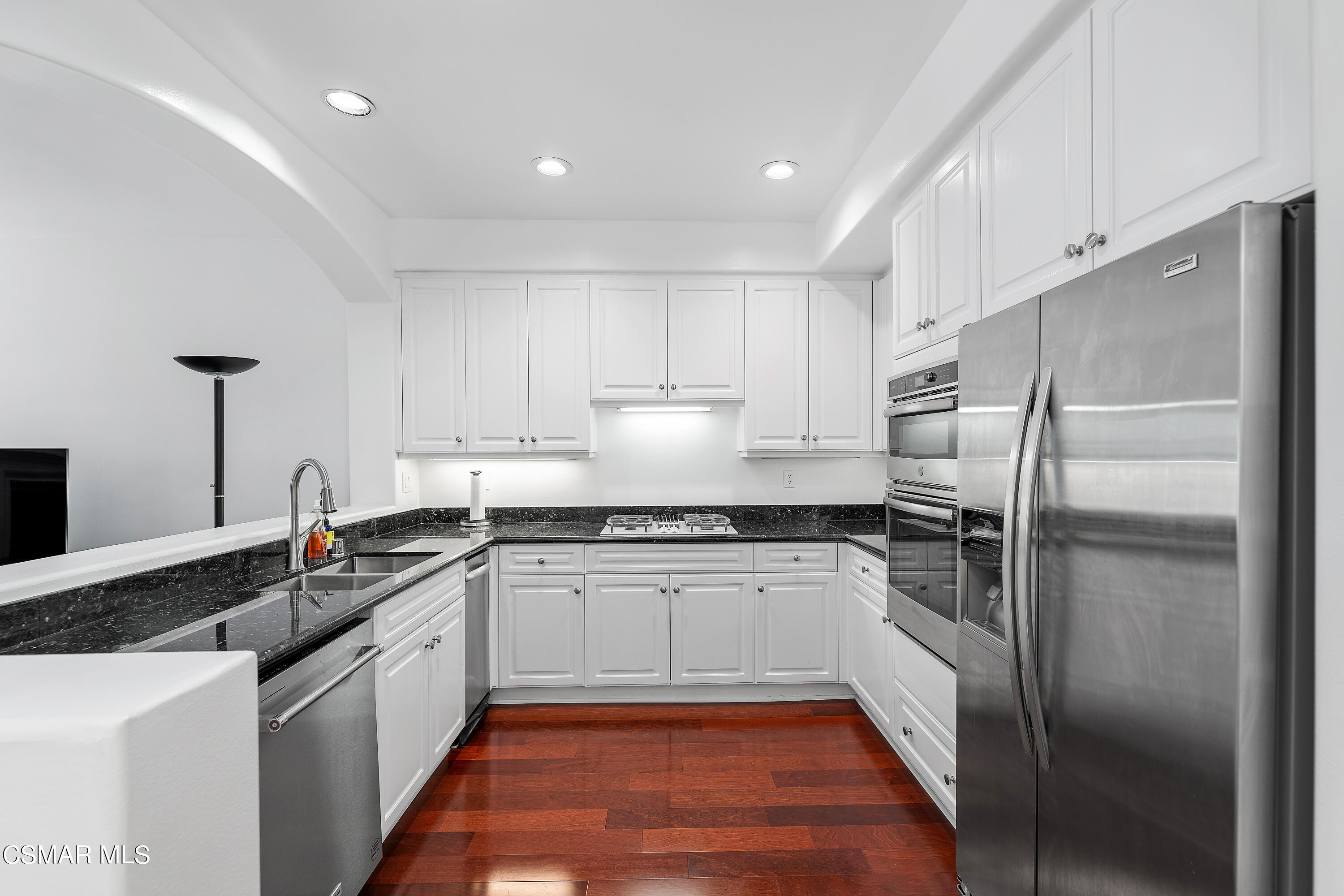 6435 Zumirez Drive, Unit 15 Malibu, CA 90265 - Photo 5 of 38 a kitchen with granite countertop a sink stainless steel appliances and cabinets