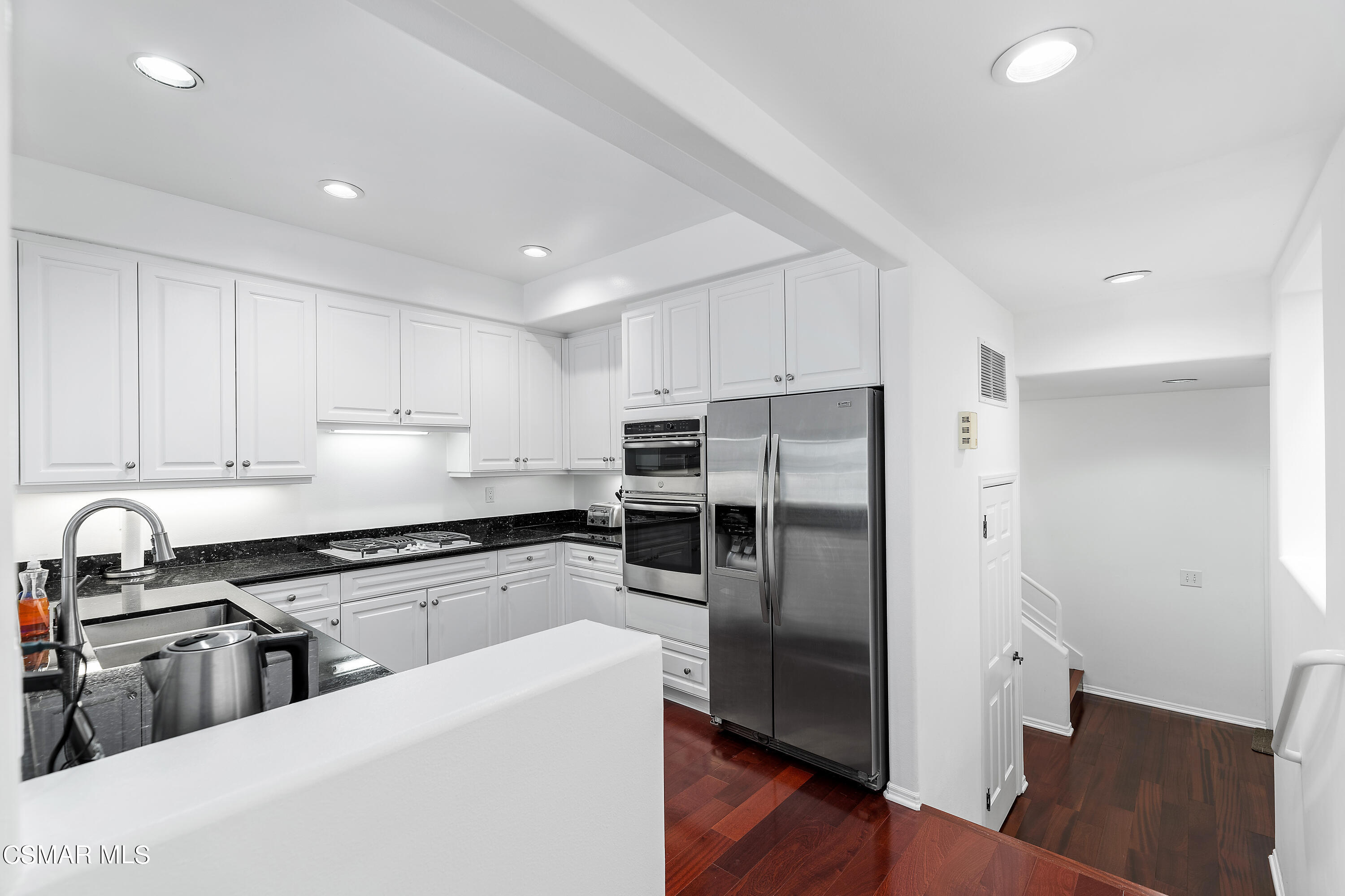 6435 Zumirez Drive, Unit 15 Malibu, CA 90265 - Photo 7 of 38 a kitchen with stainless steel appliances a refrigerator and a stove top oven