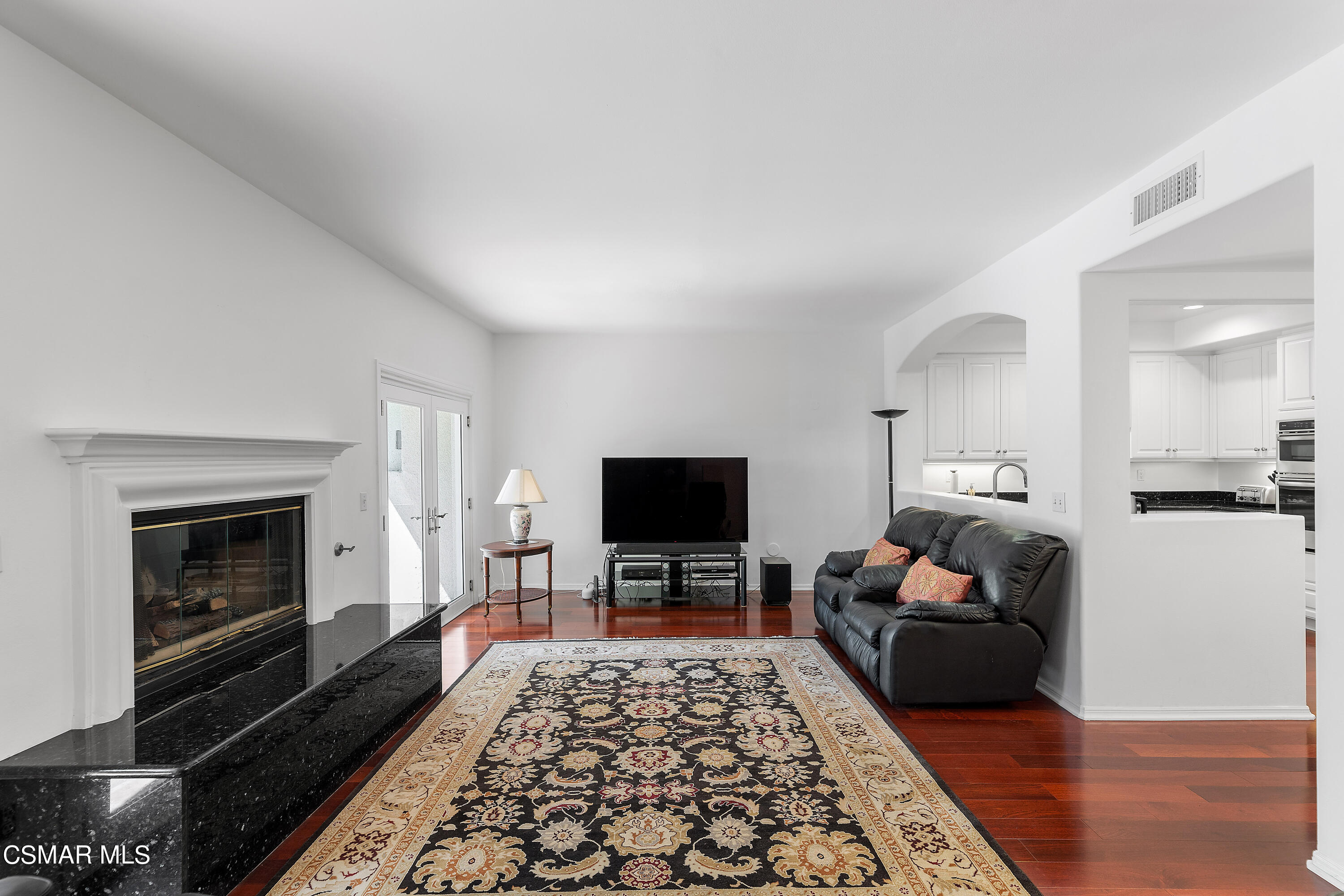 6435 Zumirez Drive, Unit 15 Malibu, CA 90265 - Photo 10 of 38 a living room with furniture and a fireplace