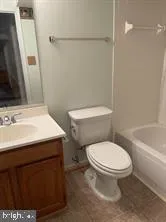 a white toilet sitting next to a bathroom sink