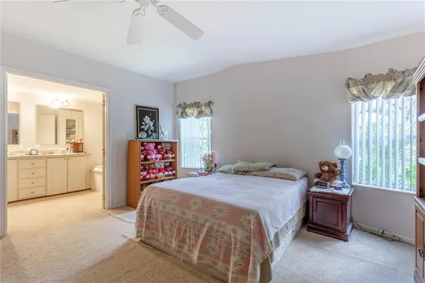 a bedroom with a bed and a view of en suite bathroom