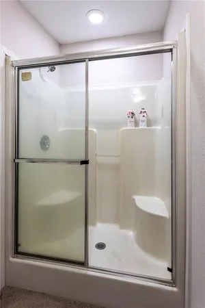 a bathroom with a glass shower door