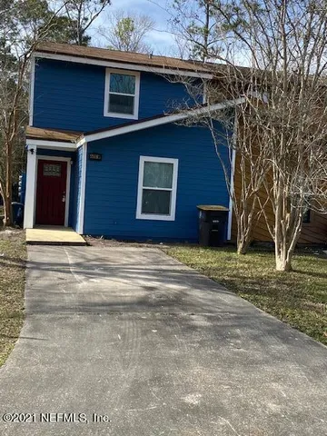 a house that has a tree in front of it