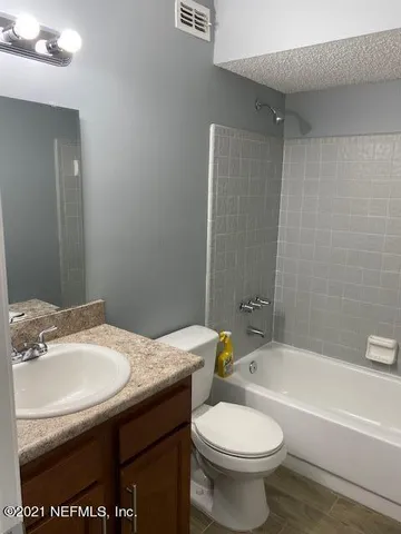 a bathroom with a sink a toilet and a bathtub