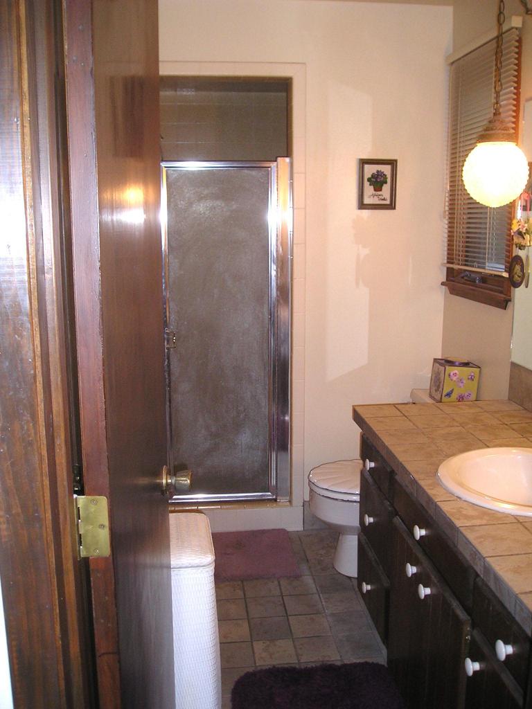 70 Miles Road Selah, WA 98942 - Photo 14 of 19 a bathroom with a granite countertop sink toilet and shower