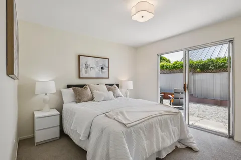 a bedroom with a large bed and a large window