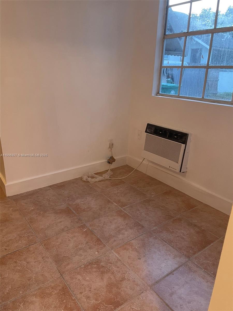 746 Northeast 80th Street, Unit GAR Miami, FL 33138 - Photo 3 of 14 a view of a room with wooden floor