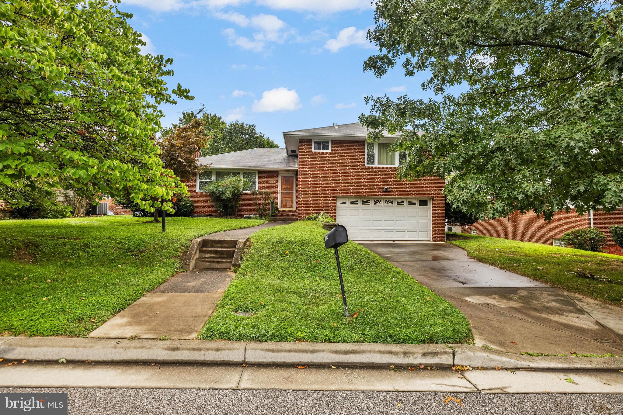 1304 Heather Hill Road Baltimore, MD 21239 - Photo 1 of 40 a front view of a house with a yard and garage