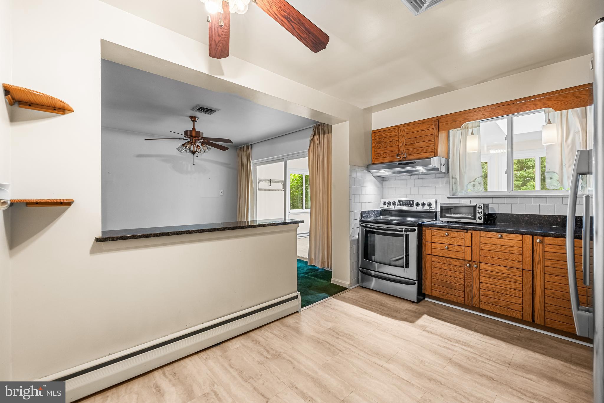1304 Heather Hill Road Baltimore, MD 21239 - Photo 12 of 40 a kitchen with stainless steel appliances granite countertop a stove a sink and a refrigerator