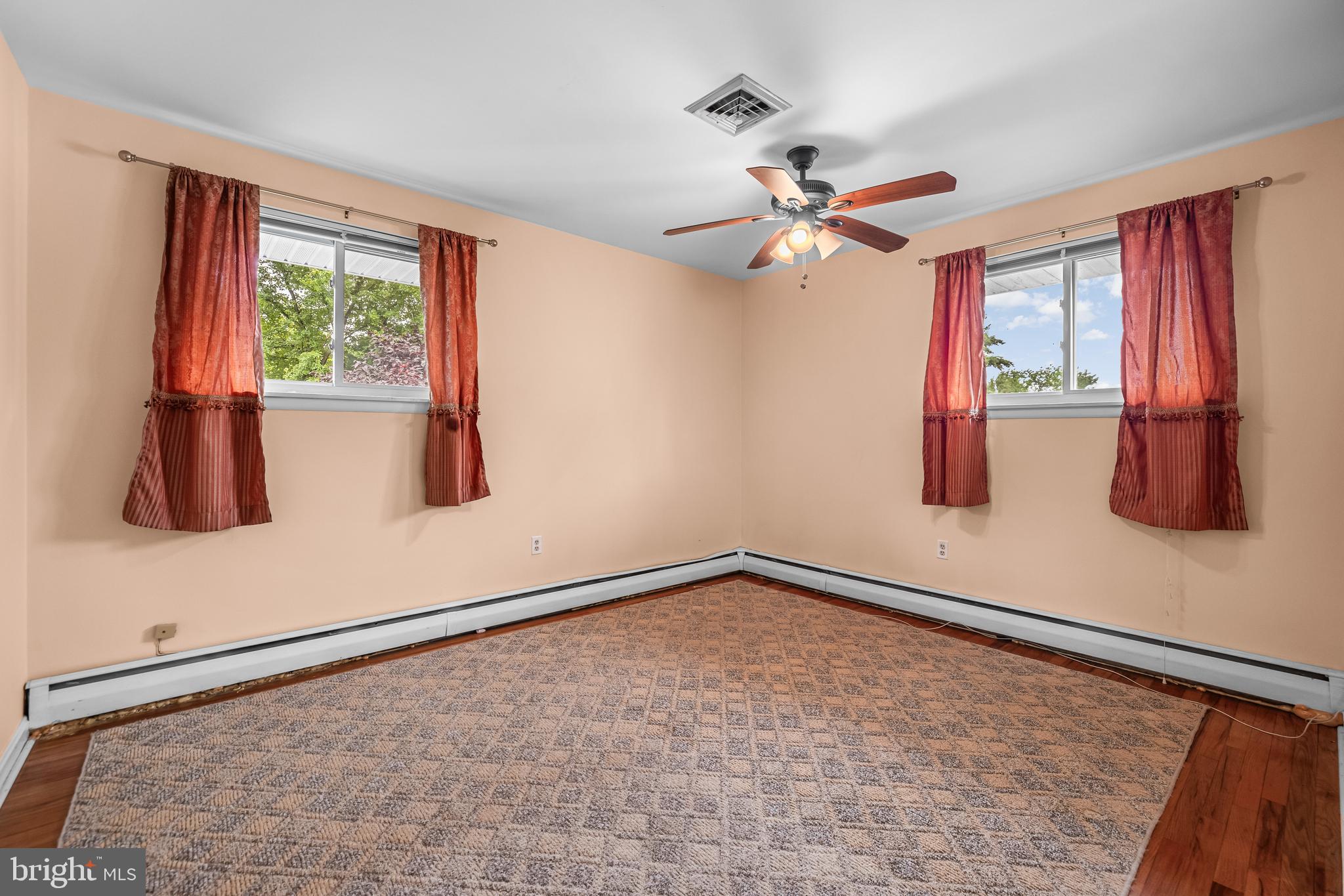 1304 Heather Hill Road Baltimore, MD 21239 - Photo 23 of 40 a view of room with window and ceiling fan