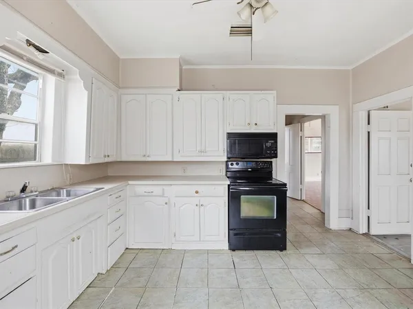a kitchen with a stove and a sink