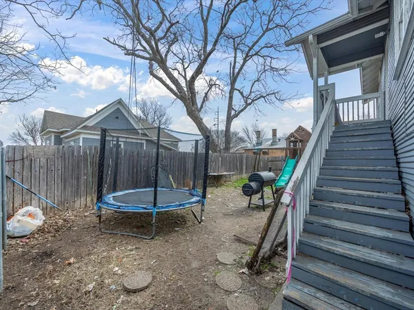 a backyard of a house with a table and chairs