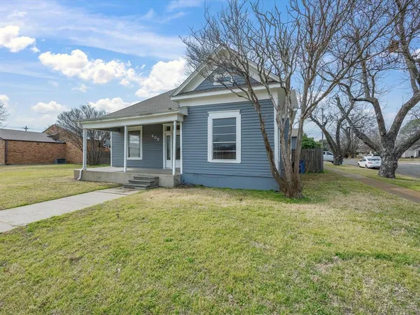 a house with huge green field in front of it