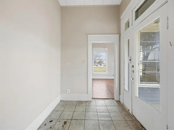 a view of an empty room and bathroom