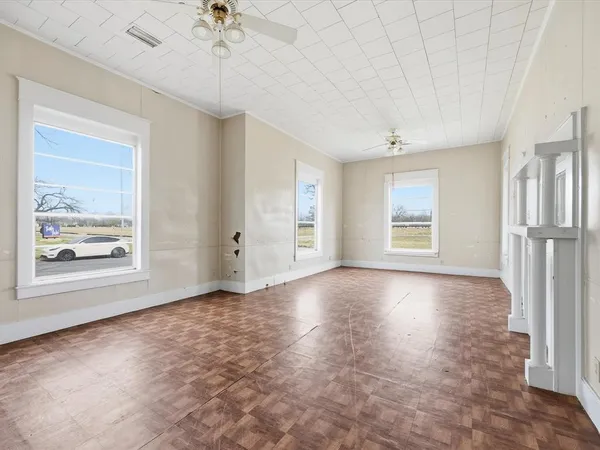 wooden floor in an empty room with a window