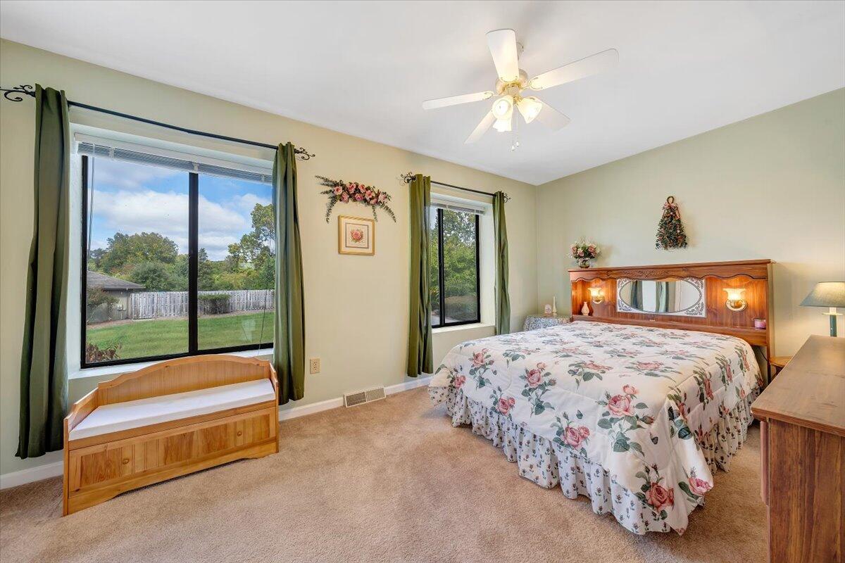 301 Harbor Ridge Drive Goodview, VA 24095 - Photo 13 of 56 a bedroom with a bed and a chandelier