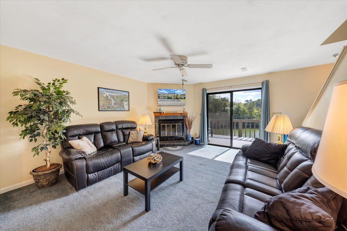 301 Harbor Ridge Drive Goodview, VA 24095 - Photo 3 of 56 a living room with furniture a large window and a fireplace