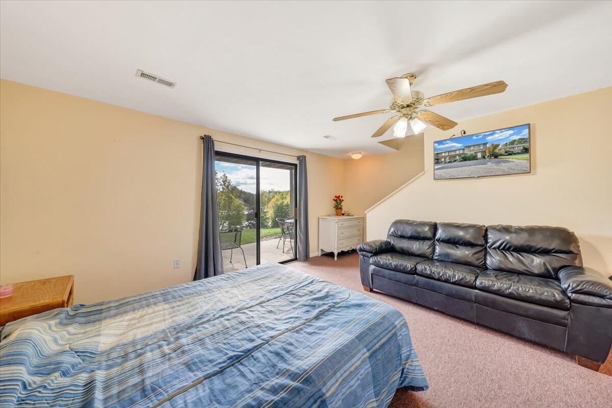 301 Harbor Ridge Drive Goodview, VA 24095 - Photo 27 of 56 a spacious bedroom with a bed a couch and a window