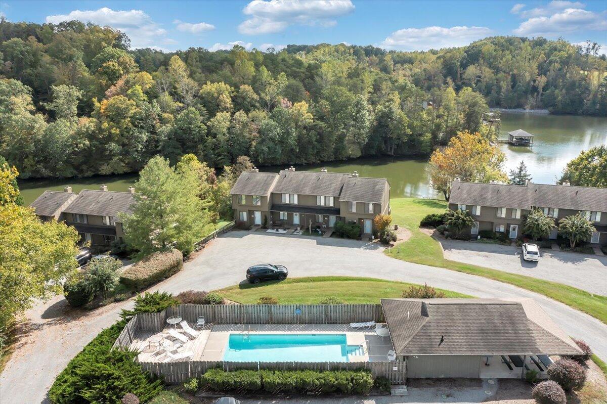 301 Harbor Ridge Drive Goodview, VA 24095 - Photo 39 of 56 a view of a swimming pool with lawn chairs under an umbrella