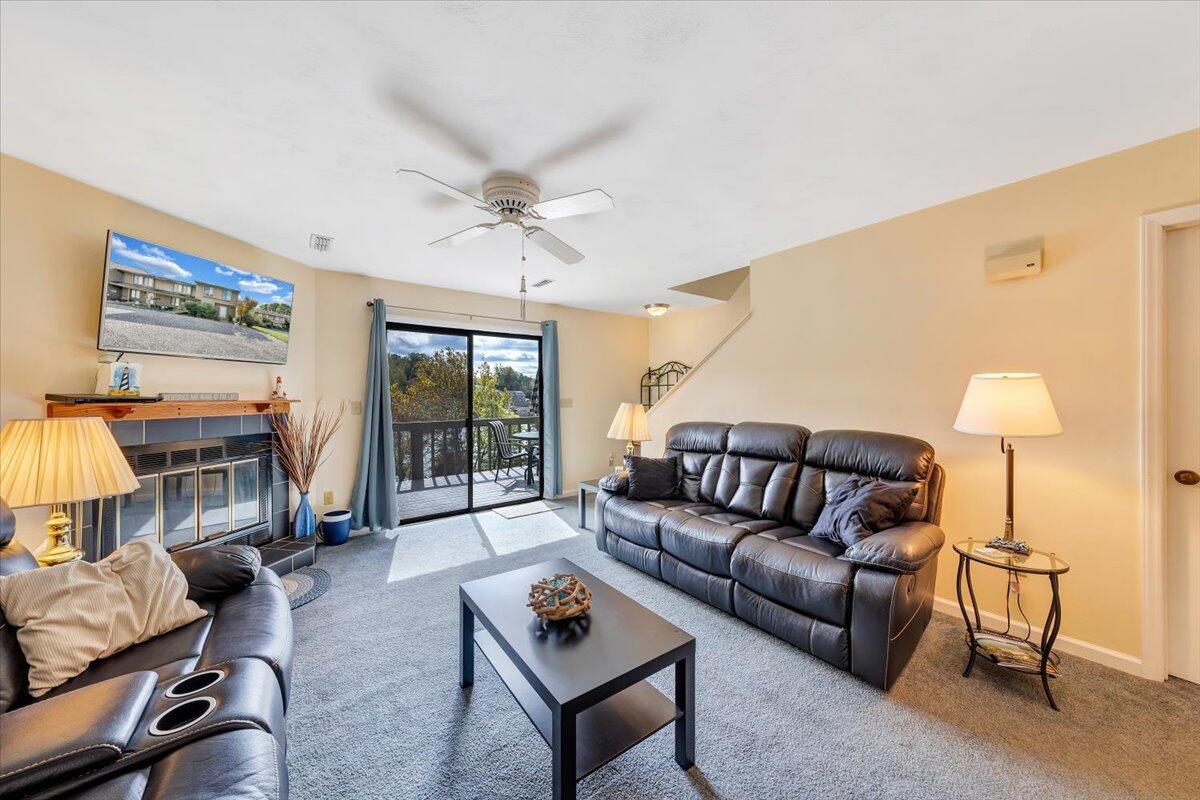 301 Harbor Ridge Drive Goodview, VA 24095 - Photo 5 of 56 a living room with furniture a ceiling fan and a window