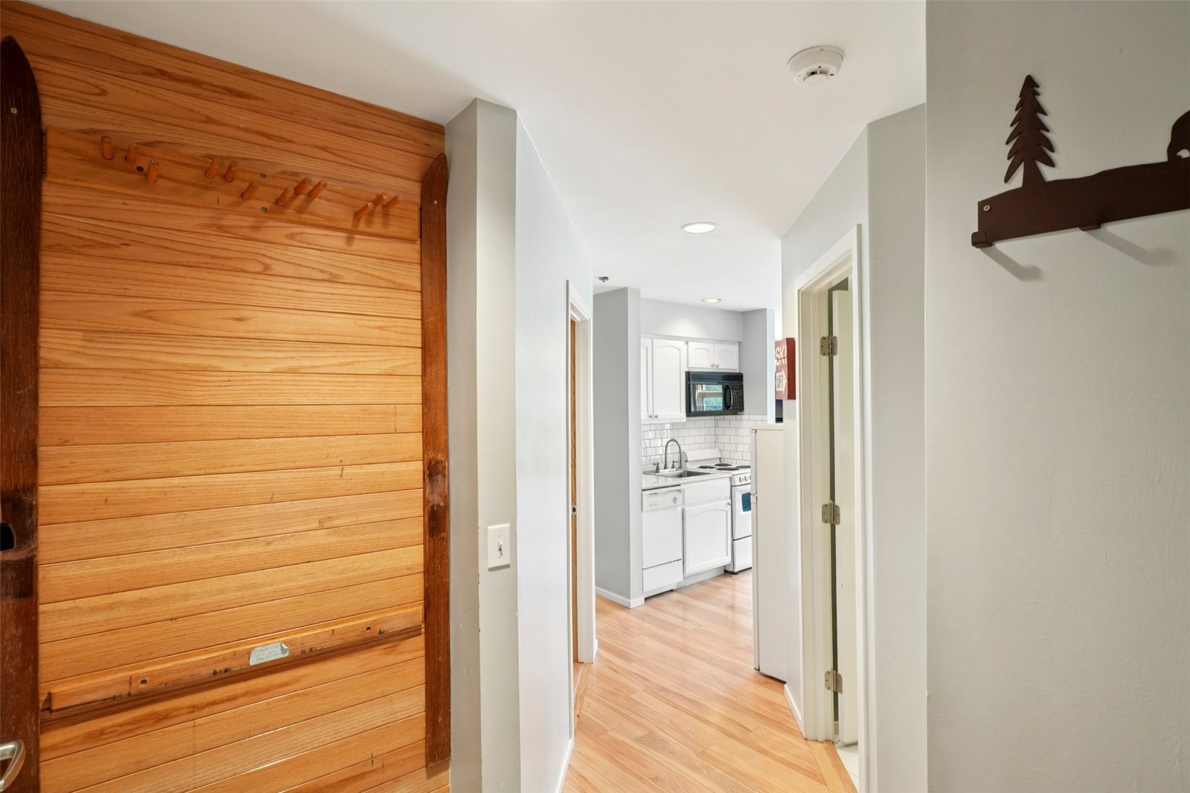 24 River Run Road, Unit 2907 Keystone, CO 80435 - Photo 11 of 37 a view of a hallway with wooden floor and a cabinet
