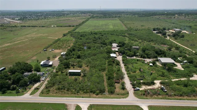 an aerial view of residential houses with outdoor space and river