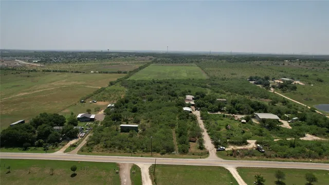 an aerial view of ocean with residential houses with outdoor space and swimming pool