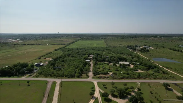 an aerial view of a golf course with houses