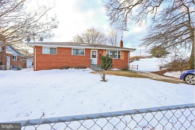 8704 Riggs Road Hyattsville, MD 20783 - Photo 1 of 25 a view of a white house with a yard covered in snow