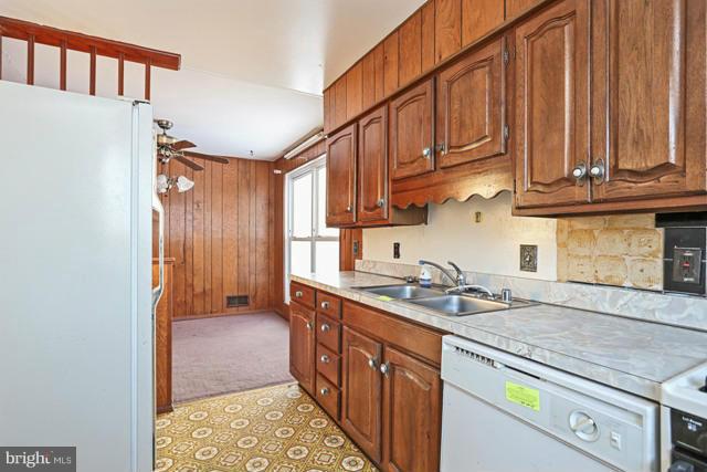8704 Riggs Road Hyattsville, MD 20783 - Photo 11 of 25 a kitchen with stainless steel appliances granite countertop a sink stove and cabinets