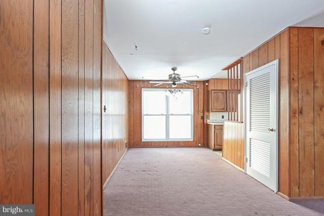 8704 Riggs Road Hyattsville, MD 20783 - Photo 20 of 25 a view of hallway with cabinets and chandelier