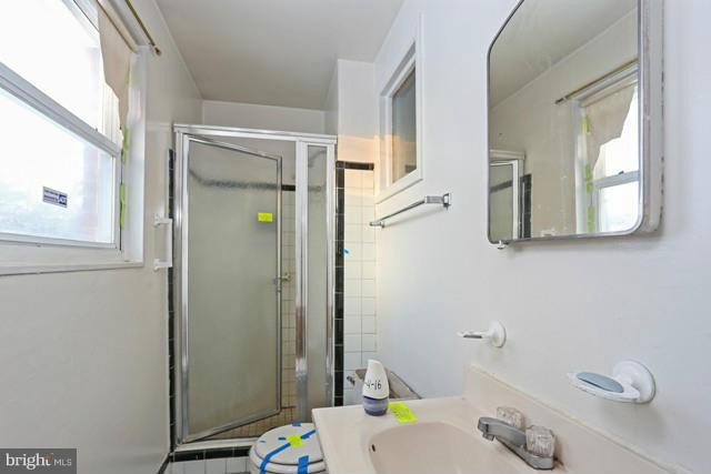 8704 Riggs Road Hyattsville, MD 20783 - Photo 6 of 25 a bathroom with a sink and a mirror