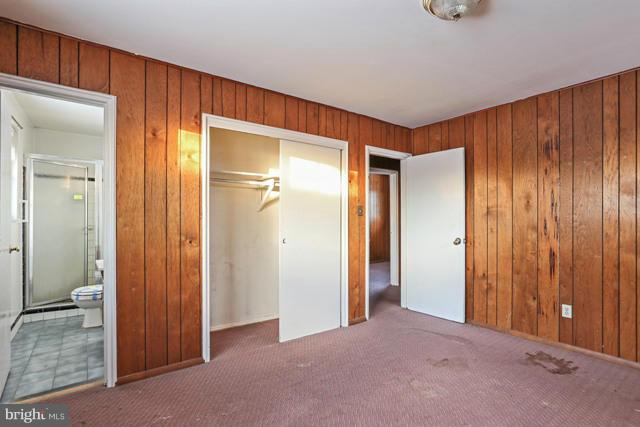 8704 Riggs Road Hyattsville, MD 20783 - Photo 7 of 25 an empty room with closet and wooden door