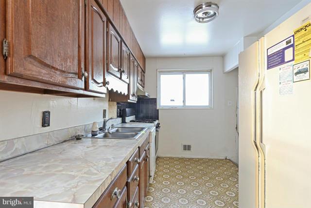 8704 Riggs Road Hyattsville, MD 20783 - Photo 10 of 25 a bathroom with a sink a vanity and a mirror