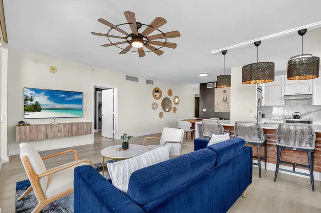 a living room with furniture and a floor to ceiling window