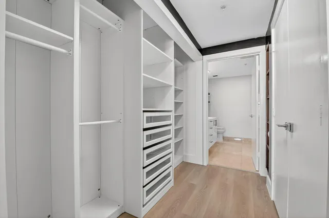 a bedroom with a bed and walk in closet